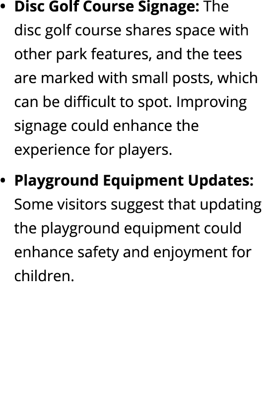 Disc Golf Course Signage: The disc golf course shares space with other park features, and the tees are marked with sm...