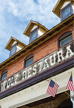 A brick building with a sign that says “Hotel Wolf Restaurant." AI generated content